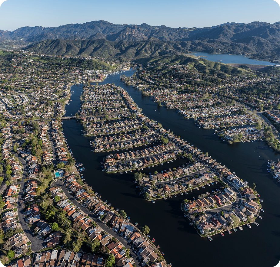 Los Angeles cityscape with high-rises, mountains, and palm silhouettes, JVRC metropolitan services